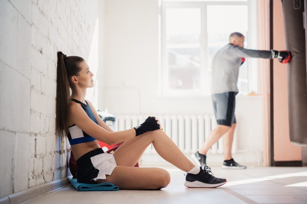 Girl boxer prepares for a fight by rolling bandages on her fists. Women's boxing